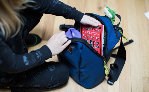 A child taking a book out of The Sprout.